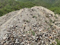 a pile of rocks and gravel on top of a mountain